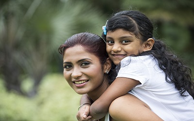 South Asian mother and child smiling