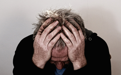 Man holding his head in his hands